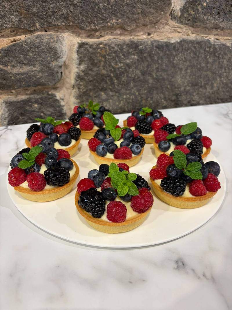 Berry tarts on a white plate.